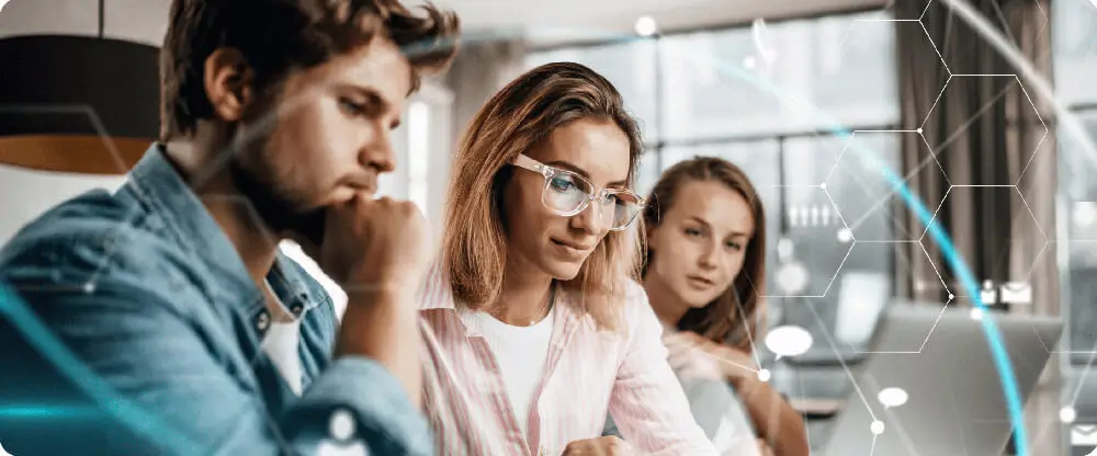 3 Business analysts looking at laptop screen