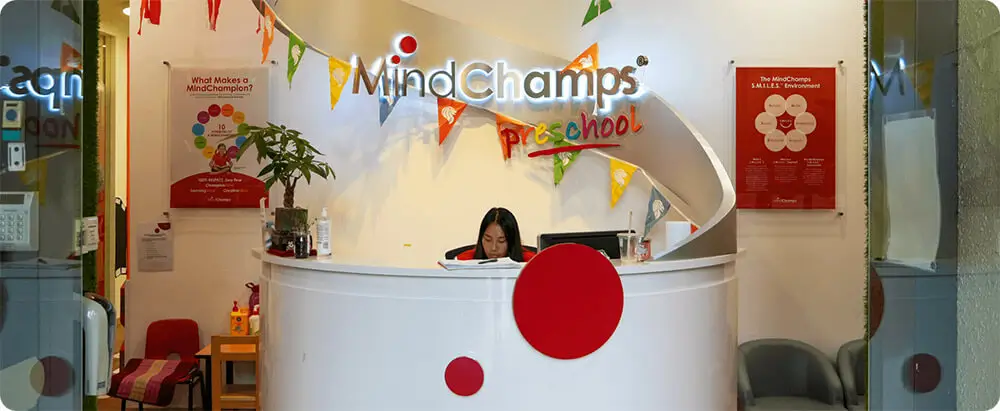 Receptionist sits behind Mindchamp reception desk